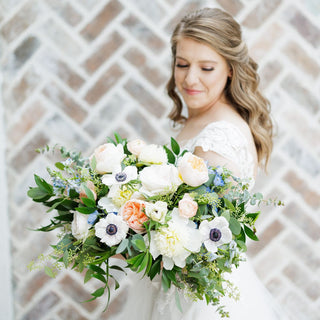 Portrait of a bride holding a beautiful wedding bouquet.
