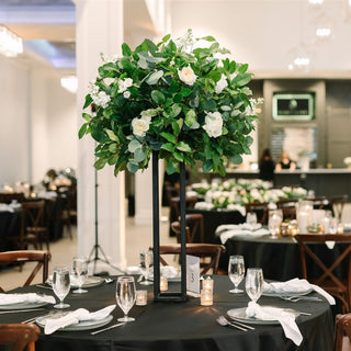 Focal shot of a wedding table centerpiece at a wedding reception.