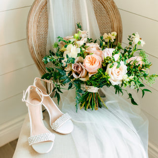 Getting ready details with bridal bouquet and bridal shoes.
